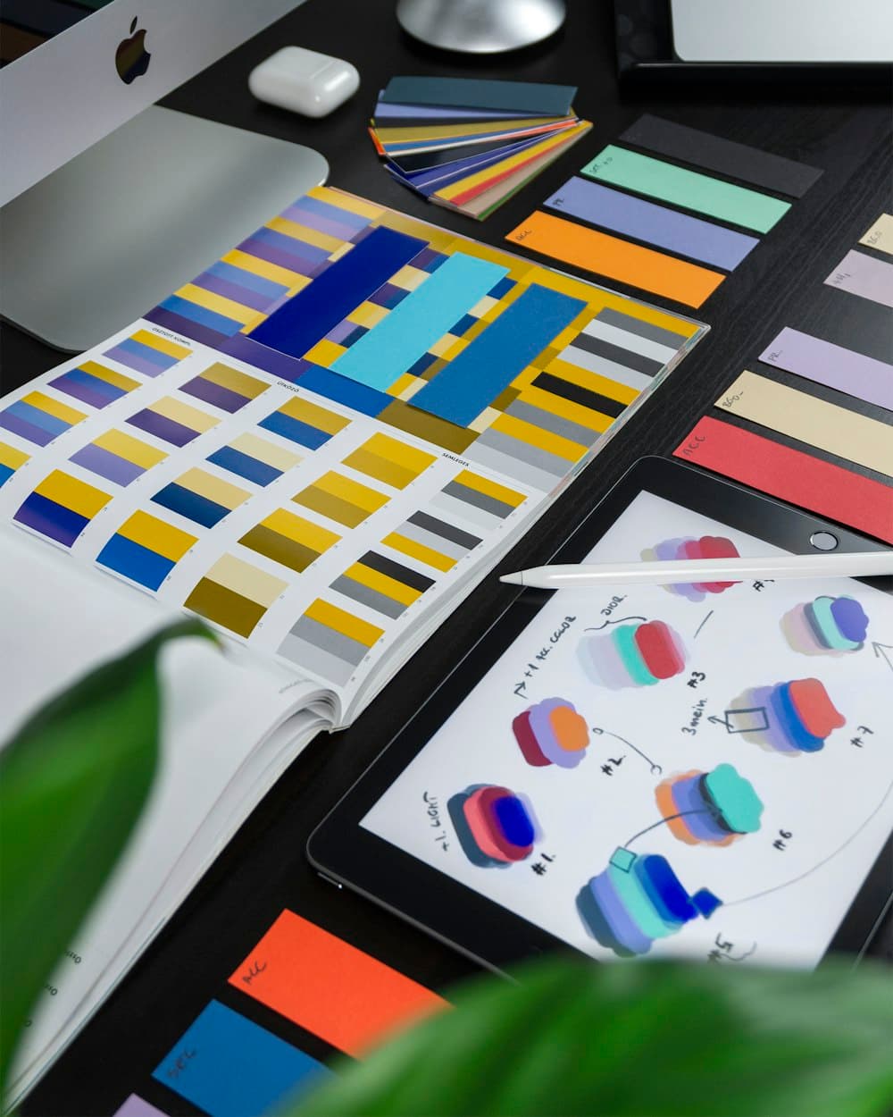 Designer's desk with colour swatches and digital sketches