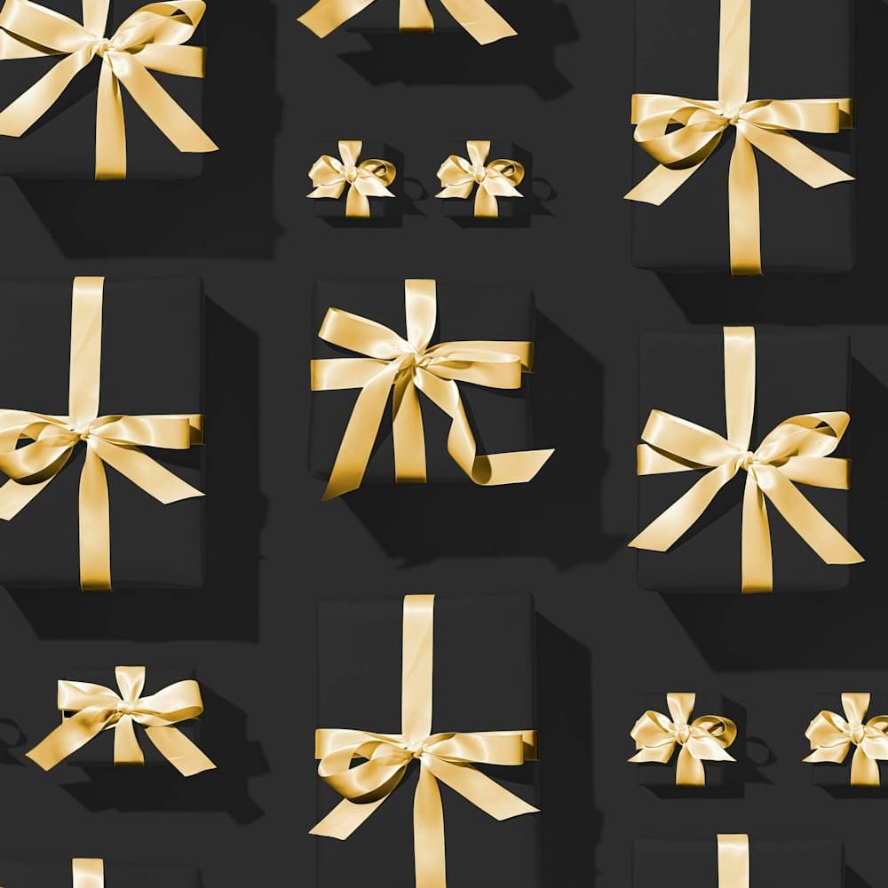 Black gift boxes wrapped with gold ribbon